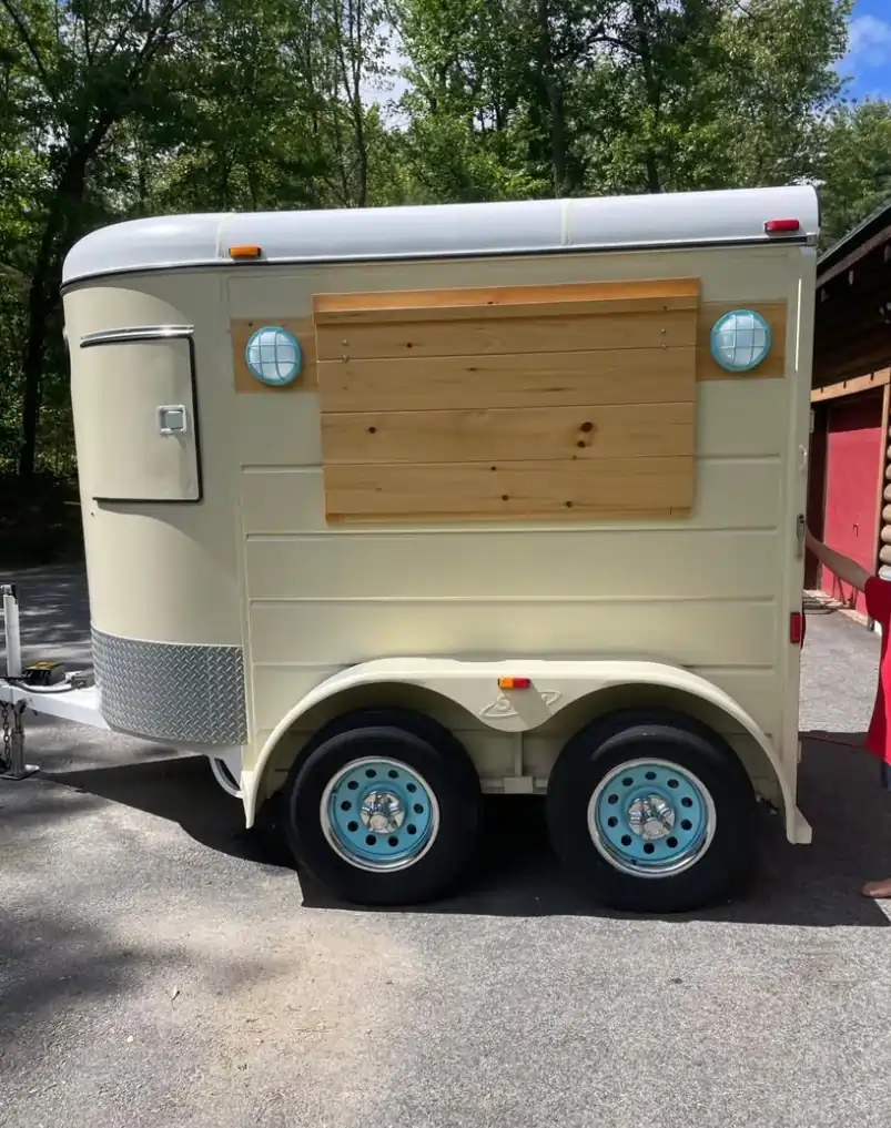 Restored vintage horse trailer in cream and robin’s egg blue serving handcrafted drinks at Hazels Homestead